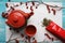 Green tea, close-up, top view Dry leaves, teapot, a Cup of tea, and red packing bag on white background