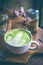 Green tea hot drink latte white cup on wood table aroma relax ti