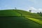 Green tea plantation hills with blue sky on background