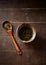 Green tea sencha in a traditional, japanese tea cup and sencha leaves on a wooden tea spoon