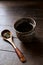 Green tea sencha in a traditional, japanese tea cup and sencha leaves on a wooden tea spoon.