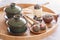 Green tea and tea ceremony attributes - ceramic teapot, cups, strainer, chopsticks and tweezers