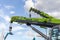 Green telescopic booms of Zoomlion QY55V and QY25V cranes at the outdoor area of the Bauma CCT Russia construction fair