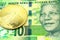 A green ten rand note from South Africa with a gold bar in macro