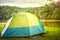 Green tent camping with sunshine in wilderness