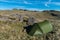 Green tent at Cold Pike in the Lake District, UK, overlooking the Crinkle Crags, Great Knott, Browney Gill and Oxendale