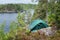 Green tent in forest, camping. Tourism, lifestyle, activity. Nature