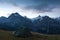 Green tent in the mountains during a colorful sunset. Night bivouac, million star hotel under night sky, tent on pass in Alps.