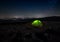 Green tent on night landscape