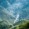 Green terraced field and smoke