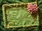 Green textile frame with rose heart