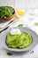 Green thin pancakes with spinach, poached egg, sour cream, lemon
