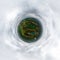 green tiny planet in blue overcast sky with beautiful clouds with transformation of spherical panorama 360 degrees. Spherical
