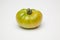 Green tomato on plain background, healthy food