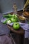 Green tomatoes and grapes on rustic background