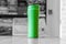 Green tourist glass thermos on the table