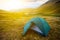 Green touristic tent among a mountains