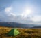 Green touristic tent stay among a mountain plateau