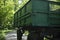 Green tractor trailer. Cart on wheels. Side of trailer. Body of transport