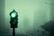 green traffic light on foggy morning, with view of misty city in the background