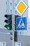 Green traffic light, pedestrian crosswalk and main road signs