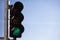 Green traffic lights for cars, blue sky background