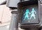 Green traffic sign Go with two female figures holding hands outside on the street in gay friendly district of Chueca in Madrid,