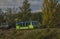 Green train of private company in summer evening near Rakovnik town