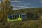 Green train of private company in summer evening near Rakovnik town