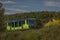 Green train of private company in summer evening near Rakovnik town