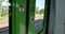 Green train`s automatic sliding door and exterior view cityscape in DÃ¼sseldorf, Germany through window.