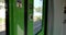Green train`s automatic sliding door and exterior view cityscape in DÃ¼sseldorf, Germany through window.