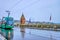 The green tram rides on Mittlere Brucke with Kappelijoch chapel on background, on April 1 in Basel, Switzerland