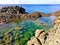 Green and transparent salt water pond by the sea in Pantelleria