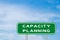 Green transportation sign with word capacity planning on blue sky