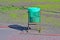 Green trash bin in sunny day, clear environment diversity,