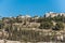 Green trees planting in the Kidron Valley or King`s Valley and residential houses at the Mount of Oliv in Jerusalem, Israel