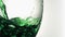 Green trickle in a super slow motion flowing in a glass