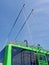 Green trolleybus bars on blue sky, power outage, parking area, urban transportation,