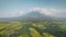 Green tropic farmlands at volcano hillside valley aerial. Legazpi town at tropical Philippine island