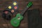 Green ukulele, headphones, vinyl discs and jeans on a wooden background