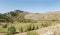 Green upland below medieval castle ruins, Rocca Calascio , Abruzzo, Italy