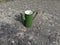 Green USSR coffee pot stands on the old asphalt covered with shards of glass from glass containers