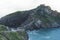 Green valley landscape on background dramatic. View sunlight blue ocean in trip holiday in basque island Gaztelugatxe. Panorama