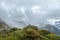 Green valley surrounded by mountains in clouds, Choquequirao trek between Yanama and Totora, Peru