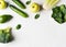 Green vegetables flat lay, avocado, broccoli, cucumber, spinach and apples from above on white background