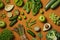 Green vegetables and fruits, greens and legumes on orange background. Healthy food and clean eating concept