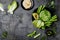 Green vegetables snack board with various dips. Hummus, herb hummus or pesto with fresh vegetables.