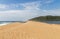 Green Vegetated Dunes Estuary and Ocean Against Blue Sky