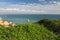 Green vegetation on seascape with stunning sea caves cliffs from ledge by camilo beach